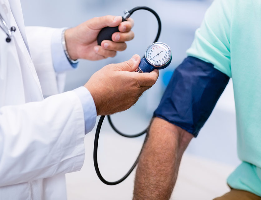 Measuring blood pressure during a health check as part of General Health Checkups in Bali.