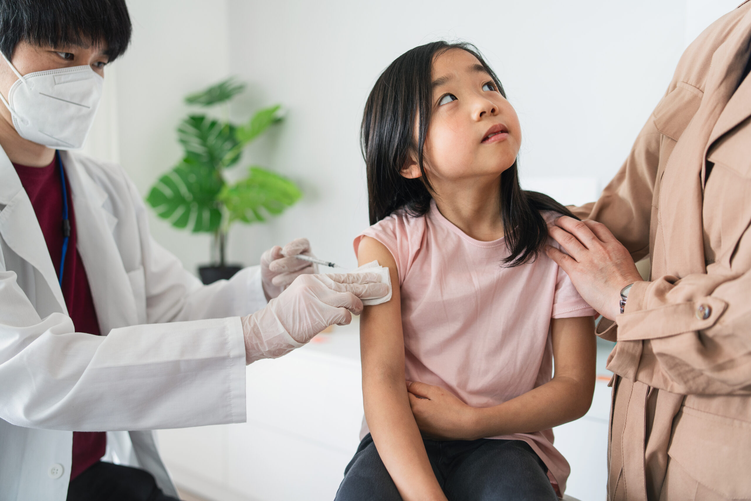 Doctor examining child during appointment at clinic, part of Nawadipa’s Child Health Services in Bali.