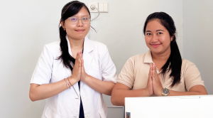 Two on-call doctors in Nawadipa Medical Care smiling during consultation in clinic.