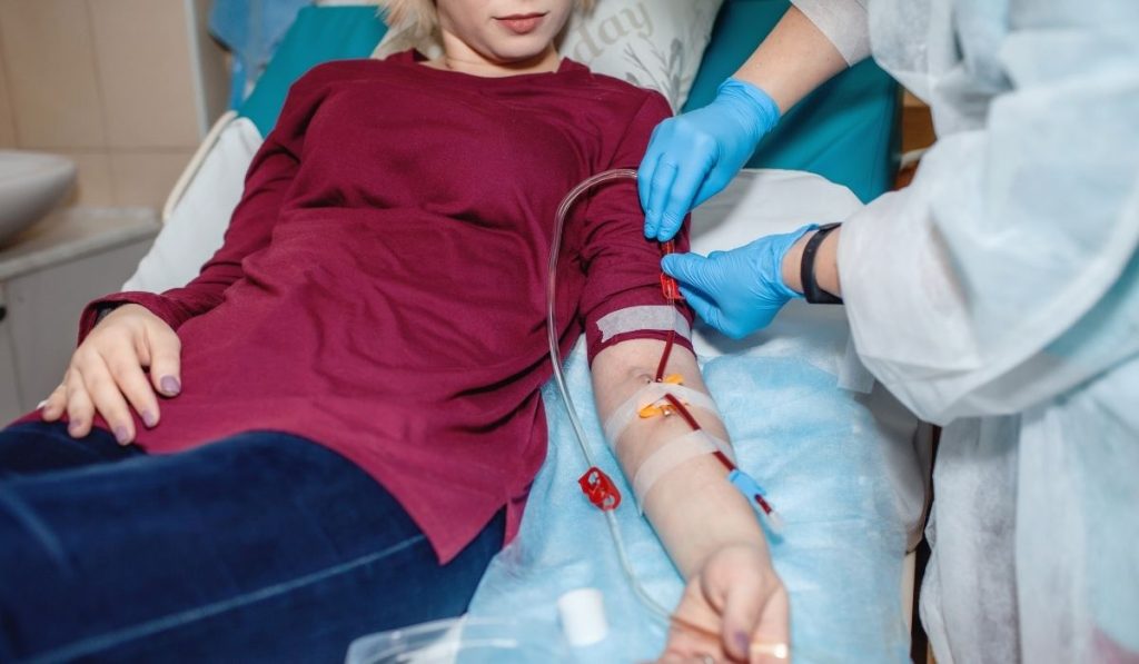 Medical staff performing IV Infusion Kedungu with sterile technique and precision.