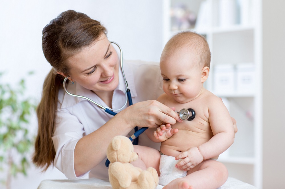 Pediatric doctor checking baby’s heartbeat during examination, highlighting Nawadipa’s Child Health Services.