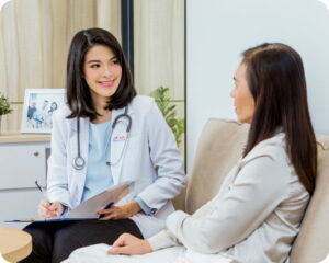 Doctor consulting female patient during home visit, representing professional oncall docter Kedungu healthcare service.